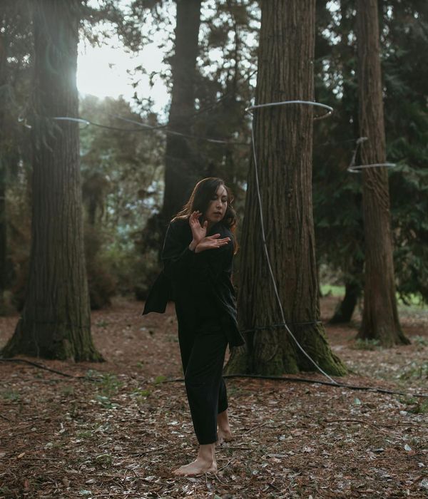 Woman performing a light, energetic movement in a calm environment.
